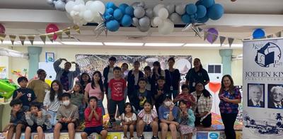 Students from Japan and the CNMI pose for a photo at the children’s library of Joeten-Kiyu Public Library.