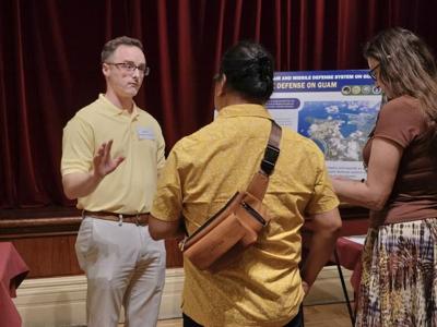 Micah Lawrence, left, a representative from the Missile Defense Agency, provides information on the proposed enhanced air and missile defense system for Guam during a meeting Wednesday, Aug. 2, 2023.
