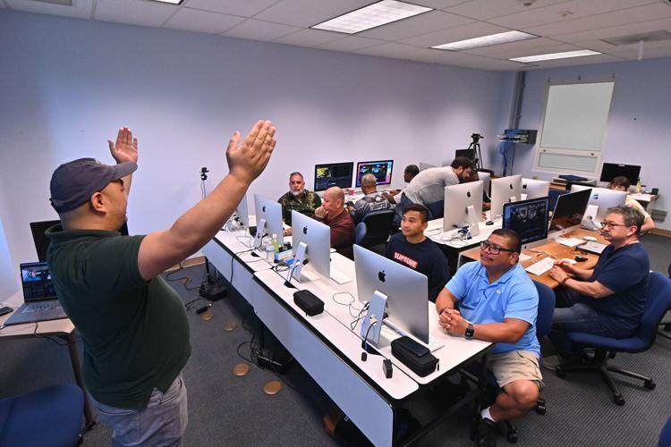 Michael Flores, left, gestures as he leads the "Voices of Veterans: Masterclass in Visual Storytelling" workshop Tuesday, Aug. 1, 2023, at the University of Guam in Mangilao.
